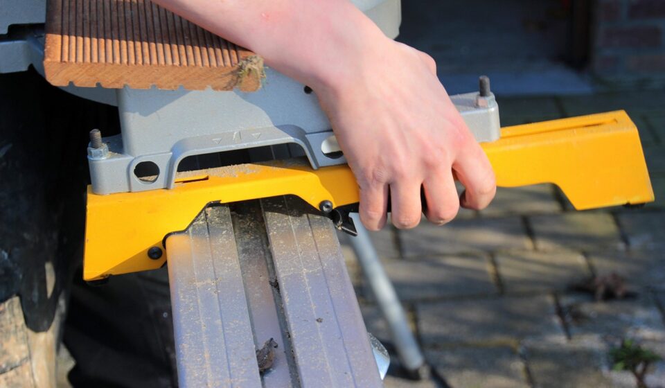 chop saw, attach to the rail, handle, rail of the chop saw, snap into place, wooden board